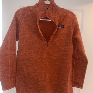 Over the head Patagonia sweater in a burnt orange color. Super cute and warm.